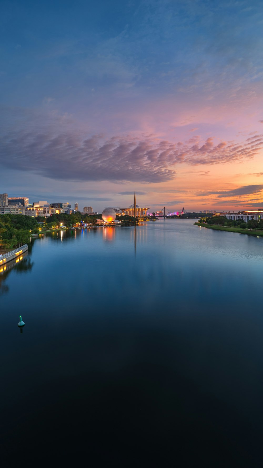 body of water below a cloudy sky during golden hour