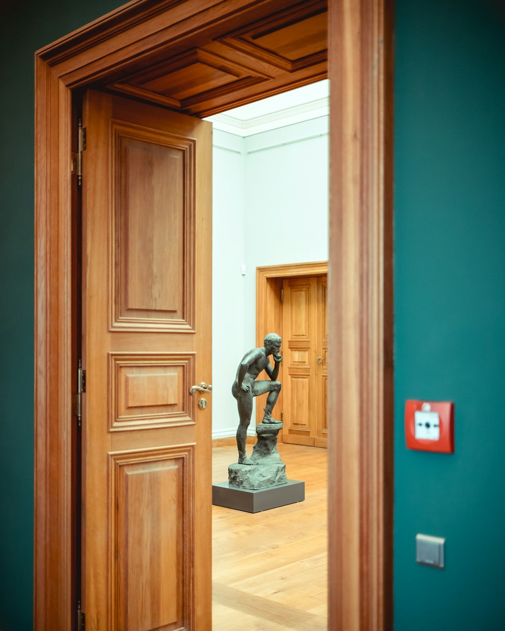 man figurine near door