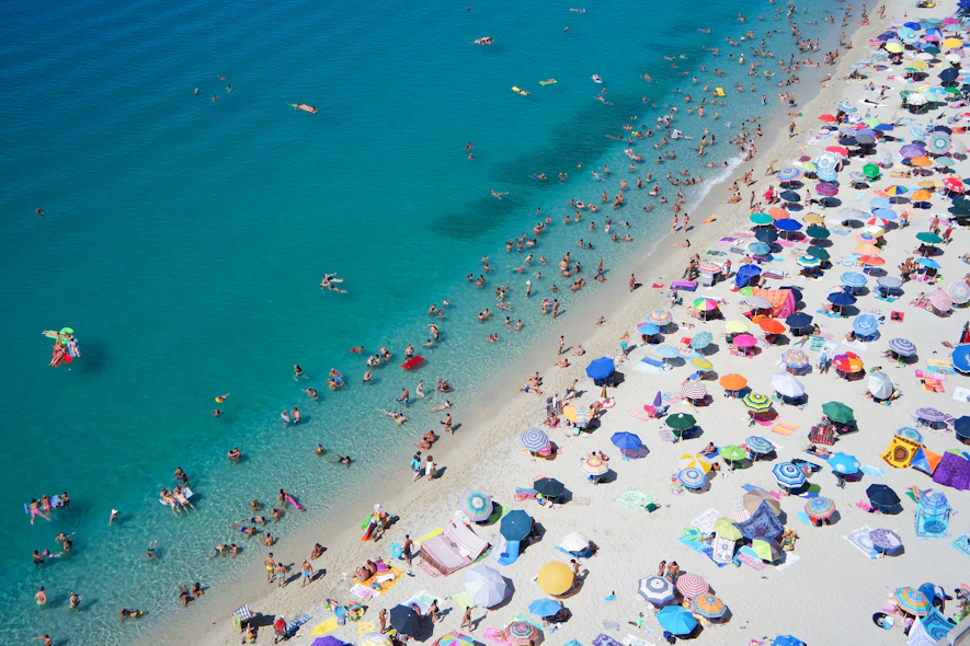 group of people swimming on beach