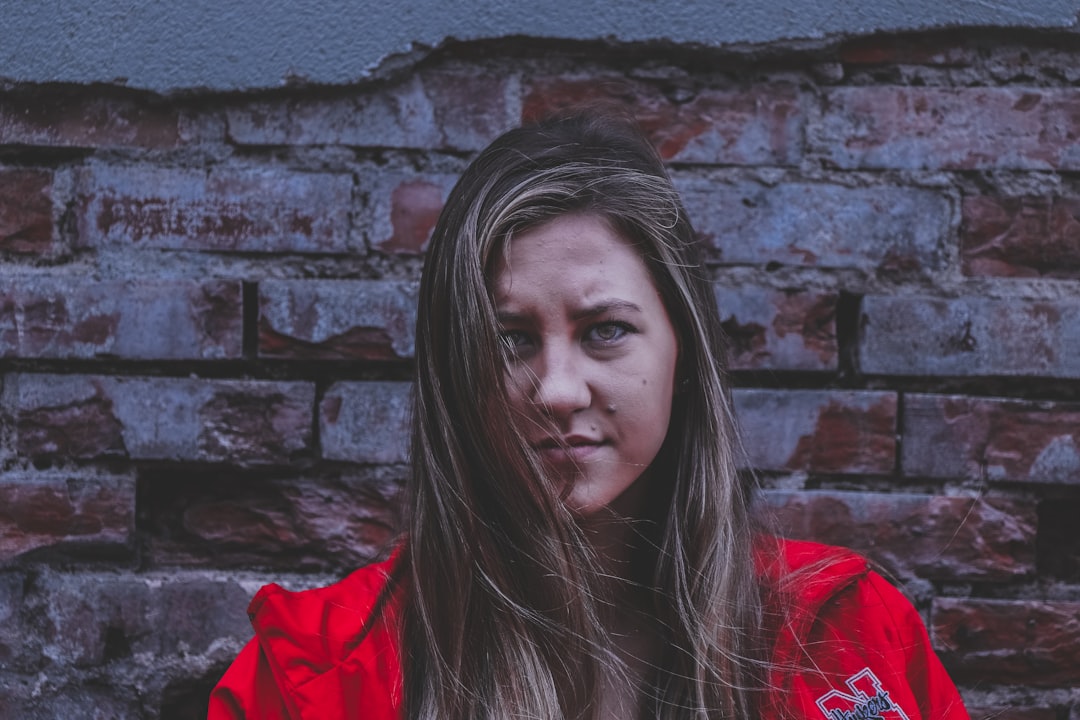 woman near brown brick wall