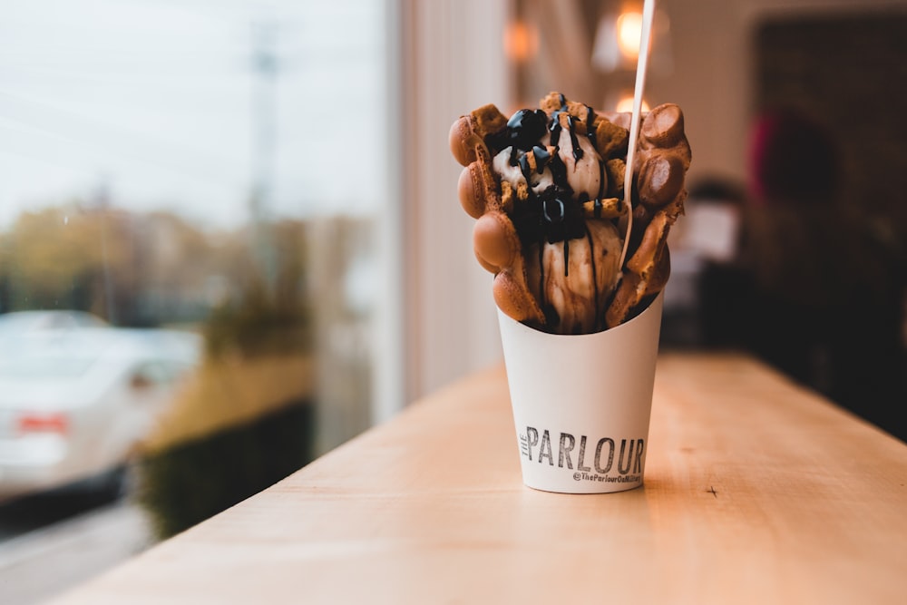 full white cup in a wooden table close-up photography