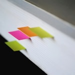 shallow focus photography of green, pink, and orange bookmarks