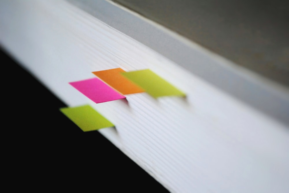 shallow focus photography of green, pink, and orange bookmarks