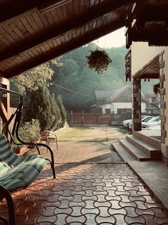 A cozy patio scene featuring waterproof outdoor curtains gently swaying in a light breeze.