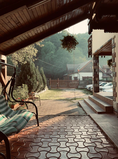A cozy backyard patio featuring Terravela’s waterproof curtains gently swaying in the breeze beside a sunlit gazebo.