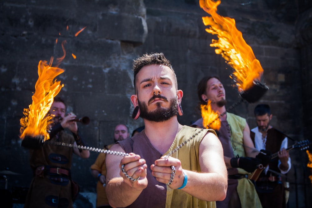 man holding chains with fire