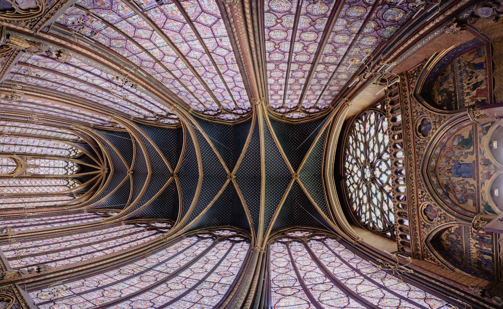 the ceiling of a building with a clock on it