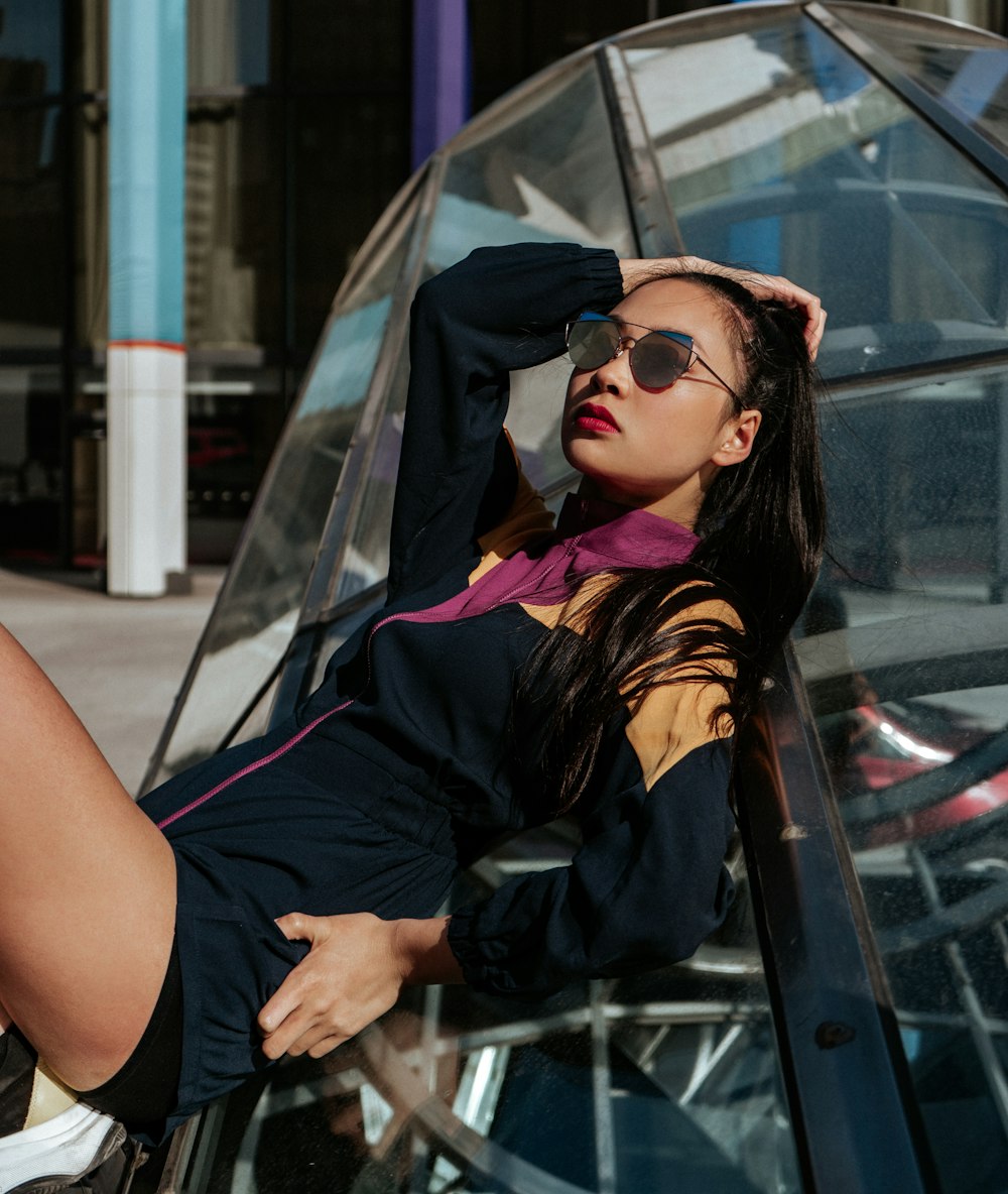 woman sitting on clear glass wall