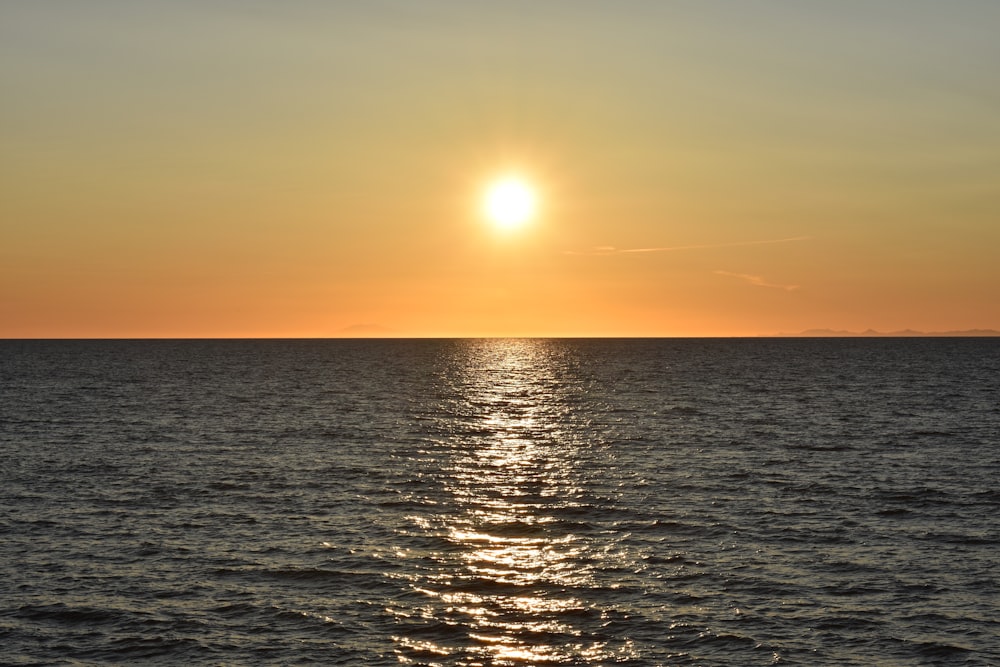 body of water during sunset