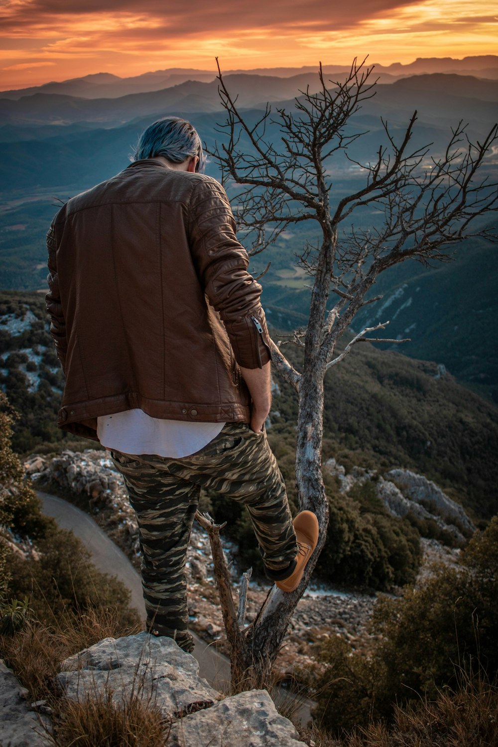 man standing while wearing brown leather jacket