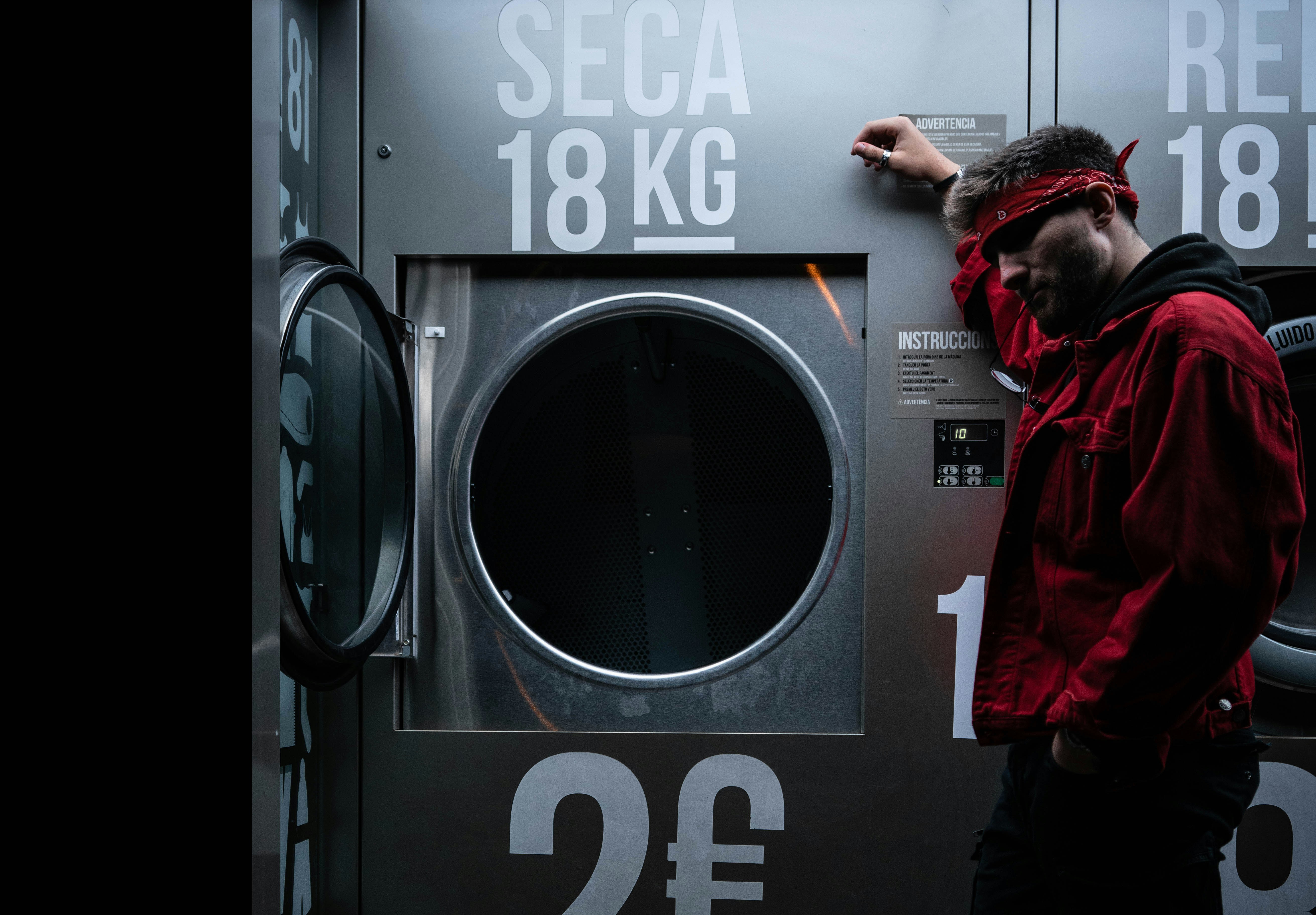 person leaning on a machine close-up photography