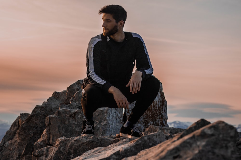 man sitting on rock