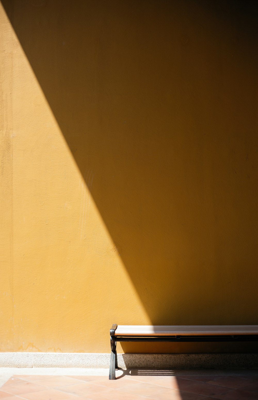 brown wooden bench near brown concrete building