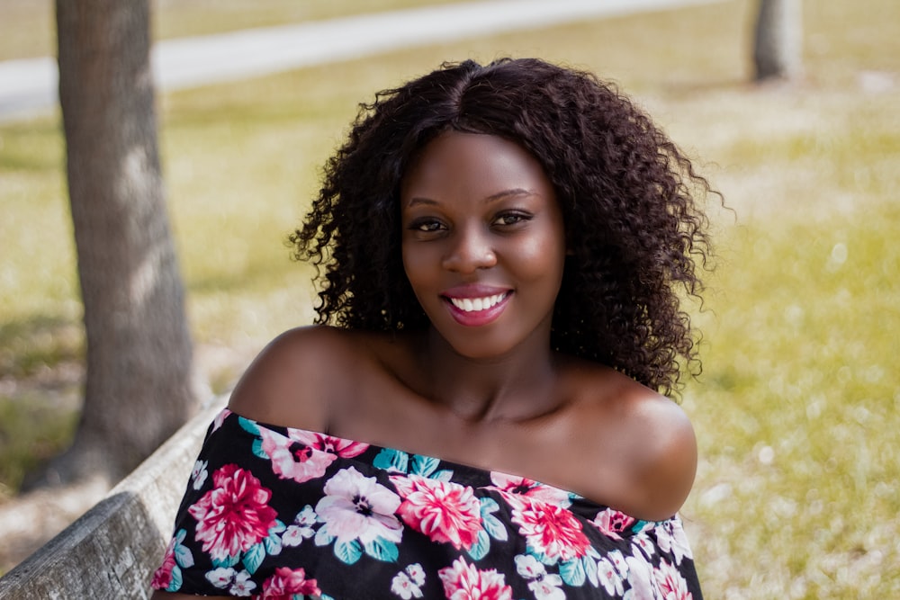 woman wearing black, white, and pink floral off-shoulder dress