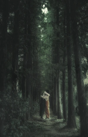 A mystical forest scene representing fantasy romance with a couple in an enchanted embrace.