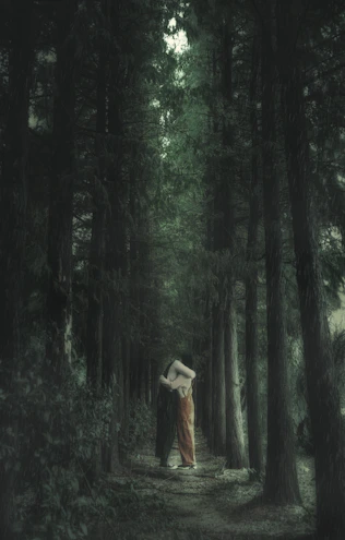 A mystical forest scene representing fantasy romance with a couple in an enchanted embrace.