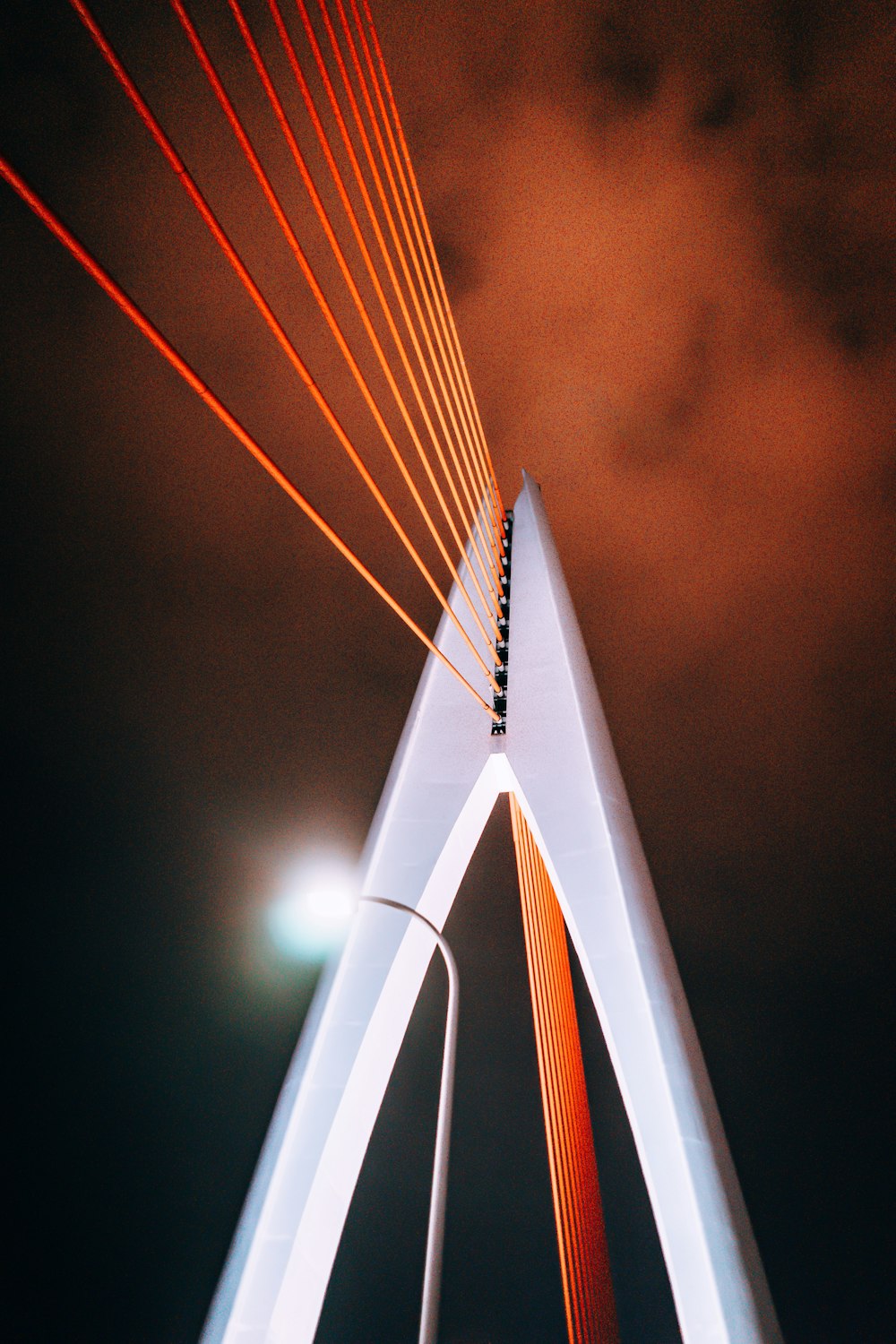 white concrete bridge with lighted lamp post during nighttime