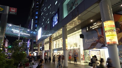 Night view of a commercial mall with vibrant 3D neon signs and effects