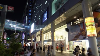 Night view of a commercial mall with vibrant 3D neon signs and effects