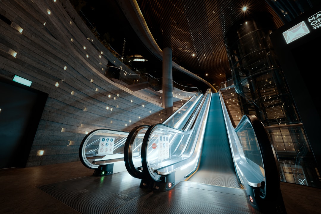 architectural photography of black escalator