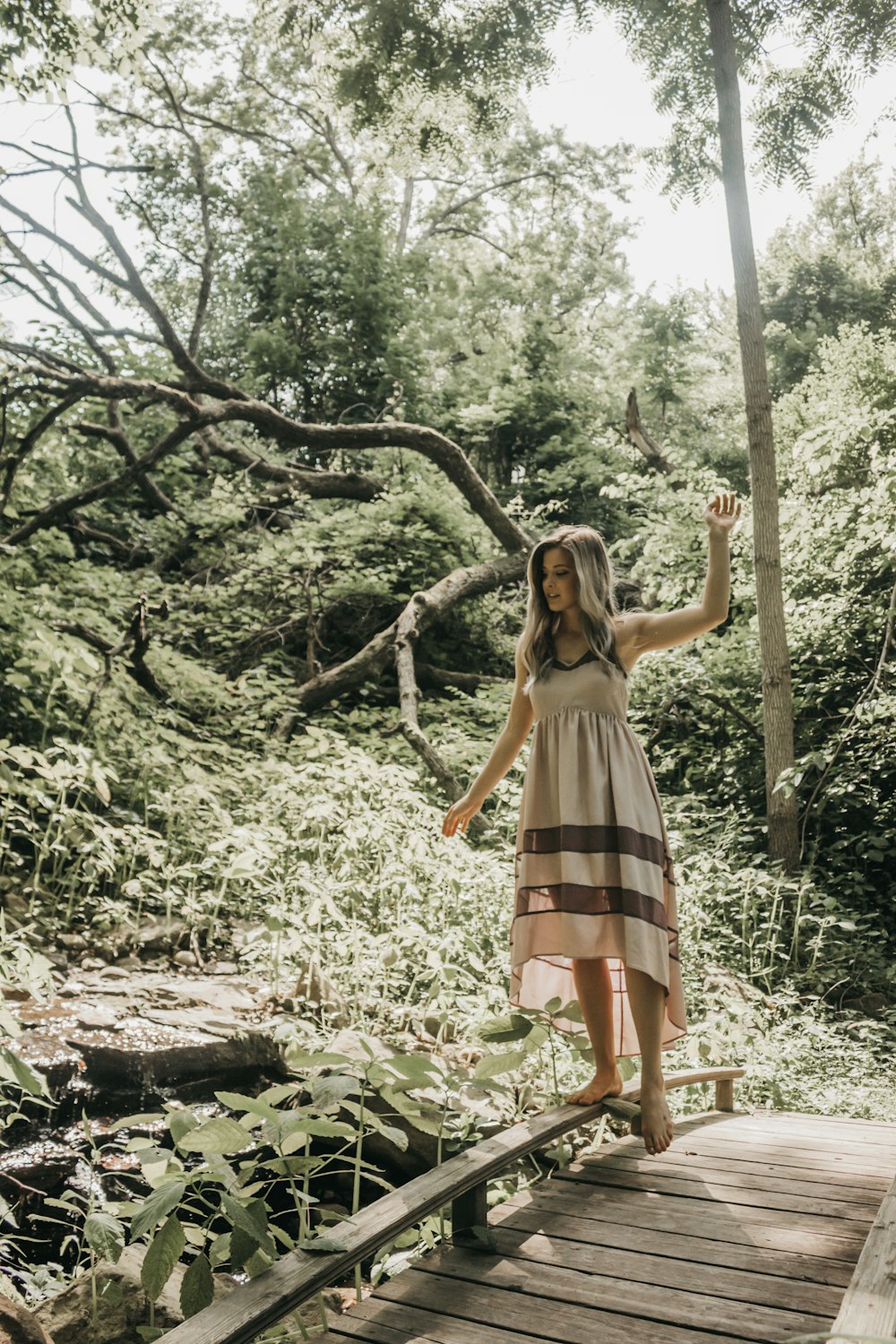 woman balancing on top of the foot bridge