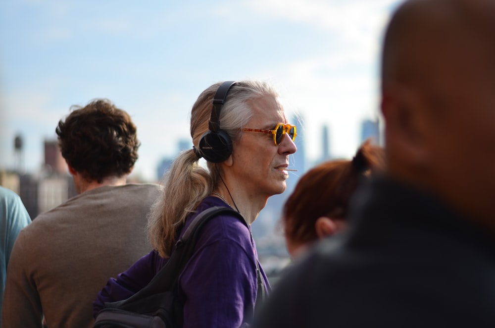 person wearing purple jacket and headphones