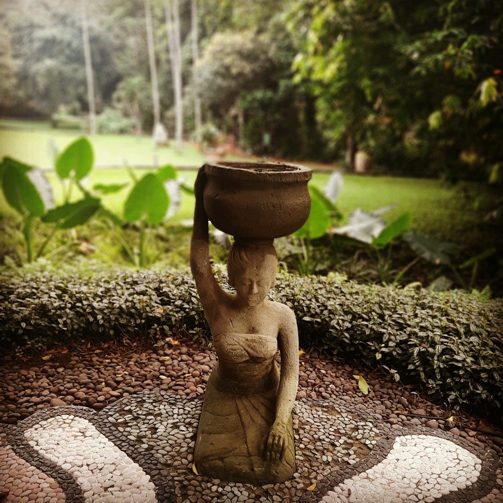 woman carrying brown pot garden decor