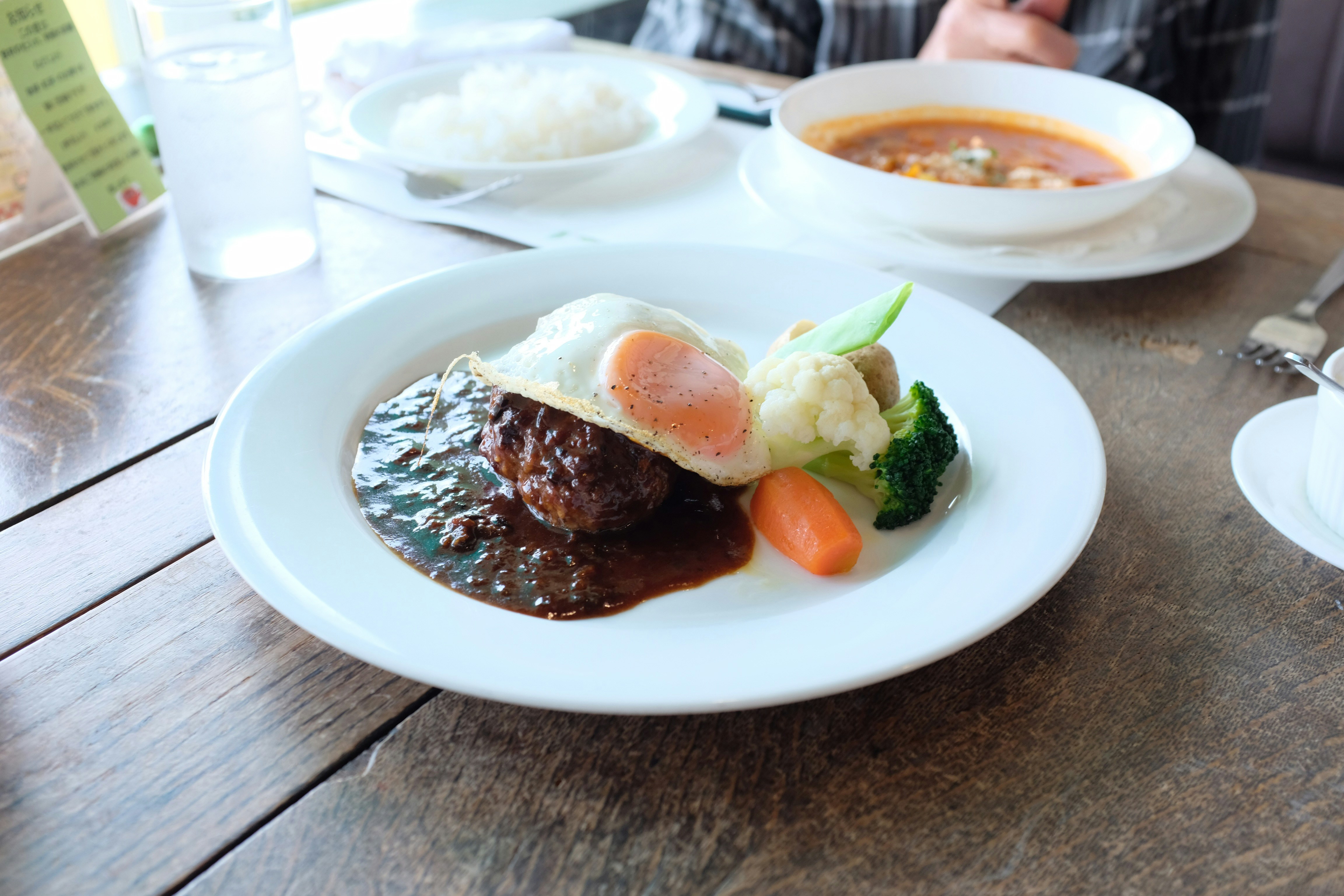 A plate of rice topped with seared meat and a fried egg, the loco moco template — finding the best loco moco on Oahu