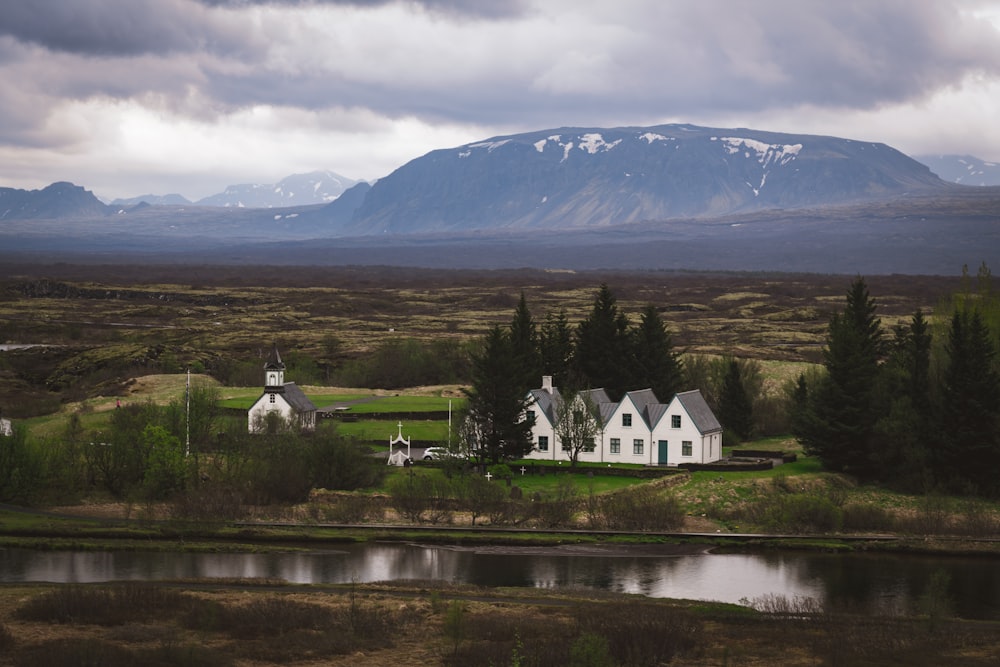 white and gray painted house near water