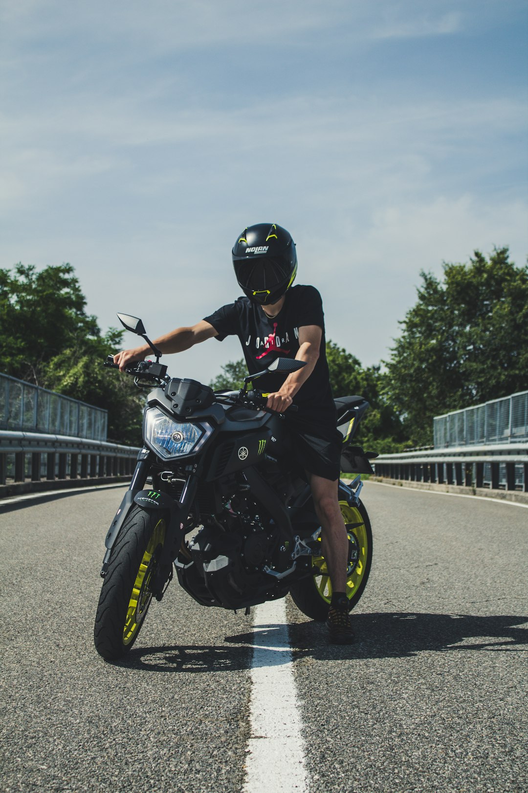 man in black Yamaha naked street motorcycle