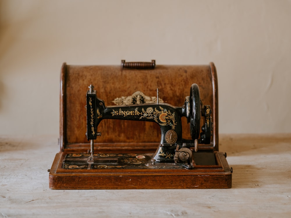 black sewing machine with brown woden case