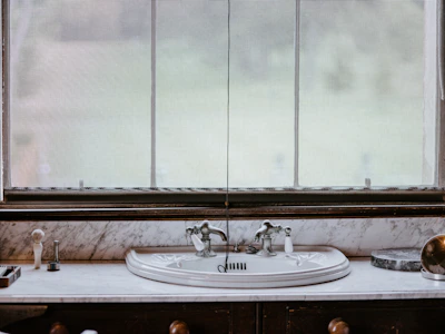 Elegant ceramic soap dispensers and toothbrush holders arranged on a marble countertop
