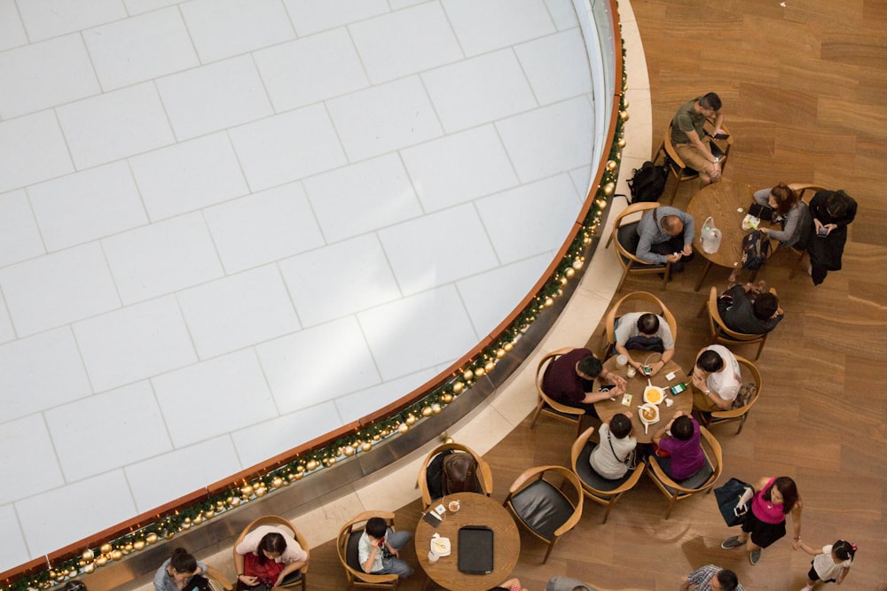 people sitting at the table beside railings