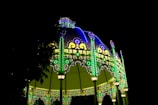 Evening shot of a trade fair stand illuminated with soft blue lighting.