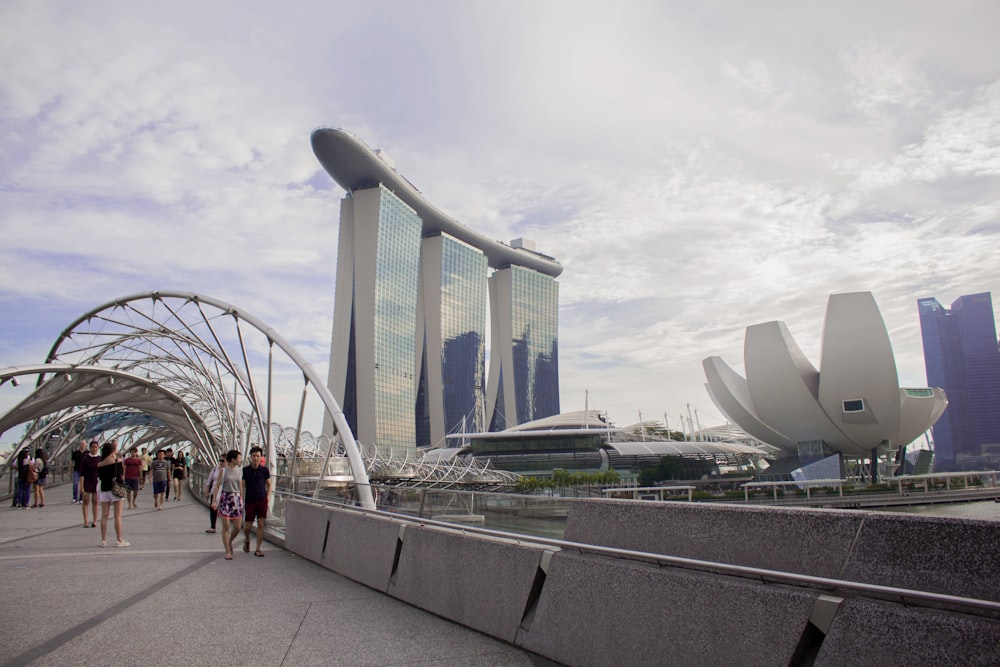 people walking near building under white skies