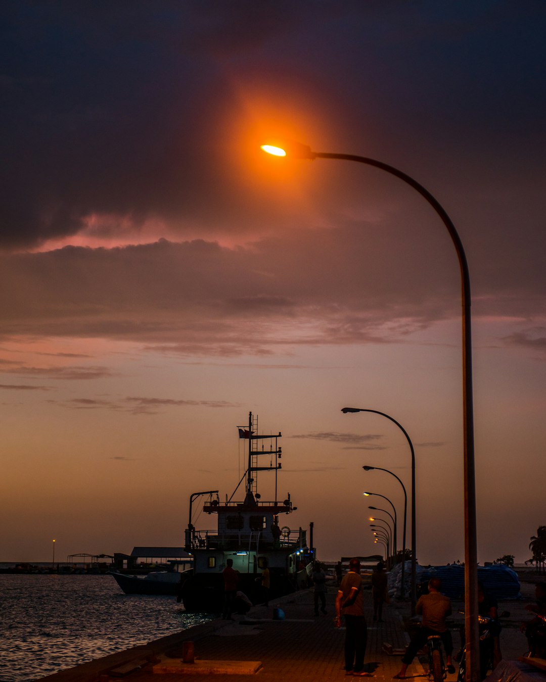 people at the pier under the light post