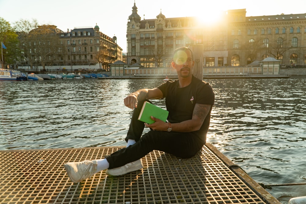 man sitting on dock