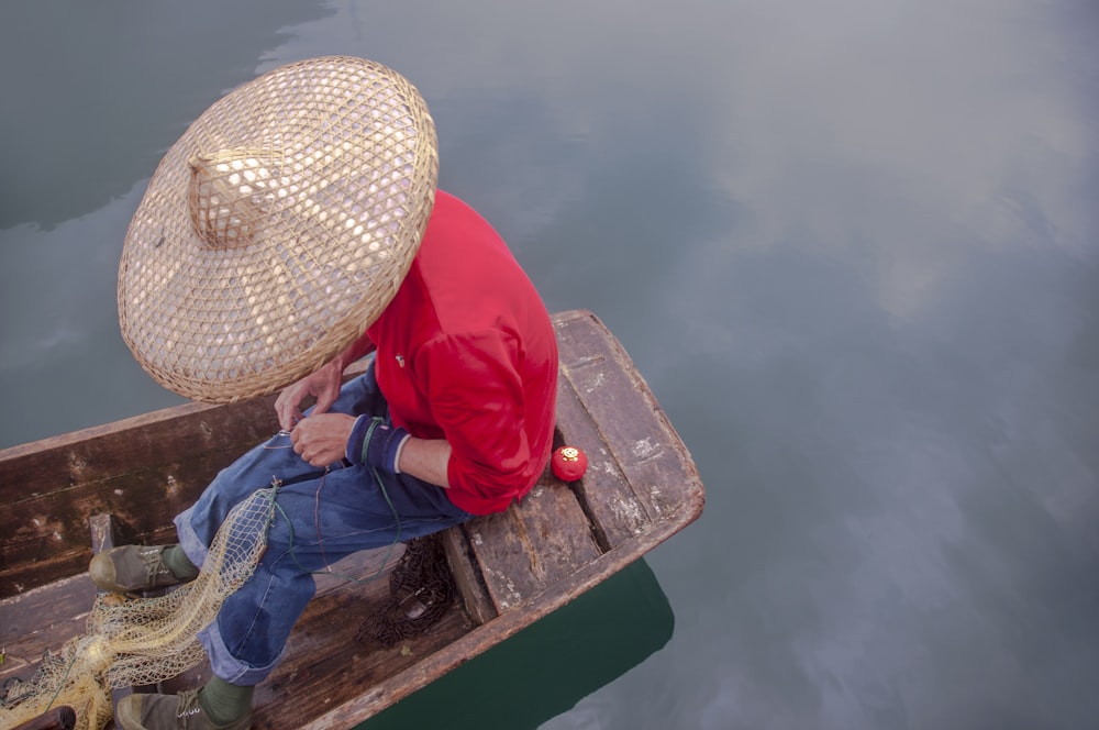 man sitting on canoe