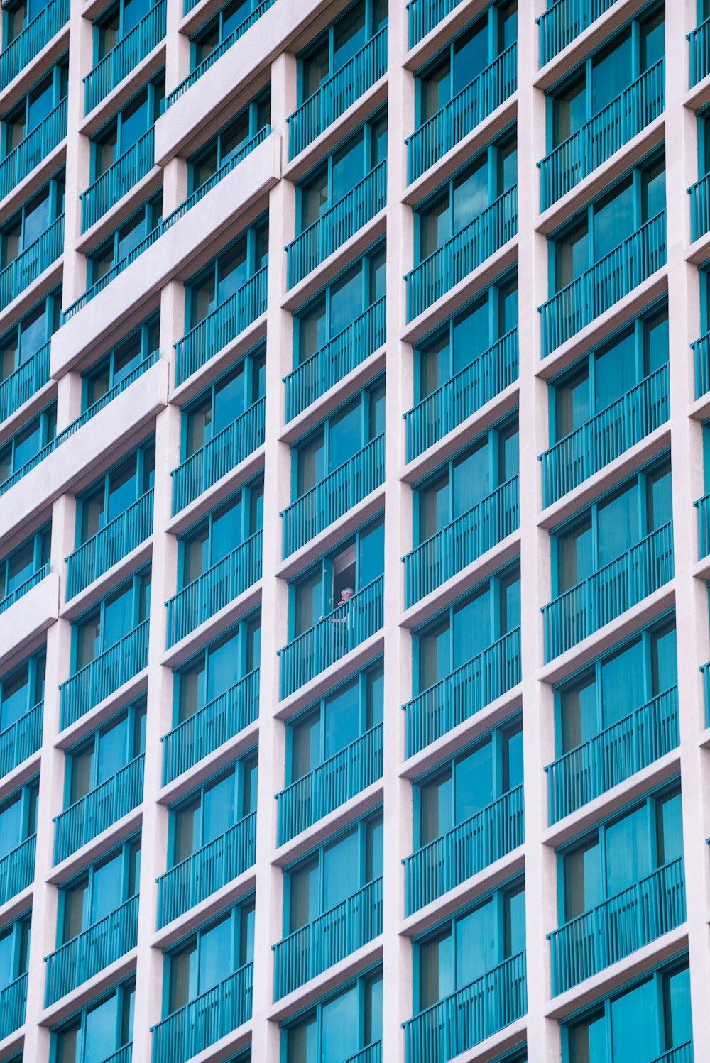 white and blue concrete high-rise building with terraces