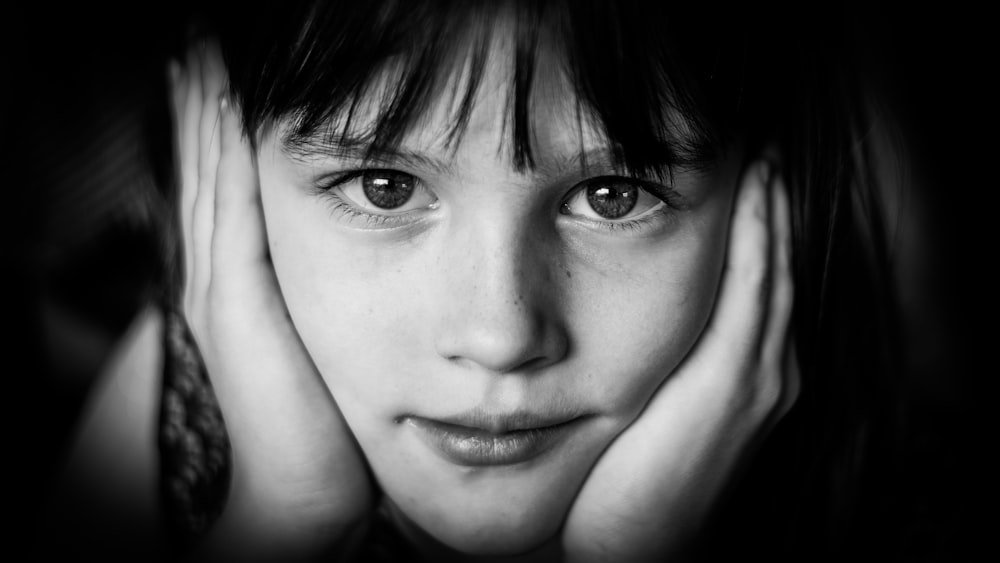 girl's face in grayscale photo