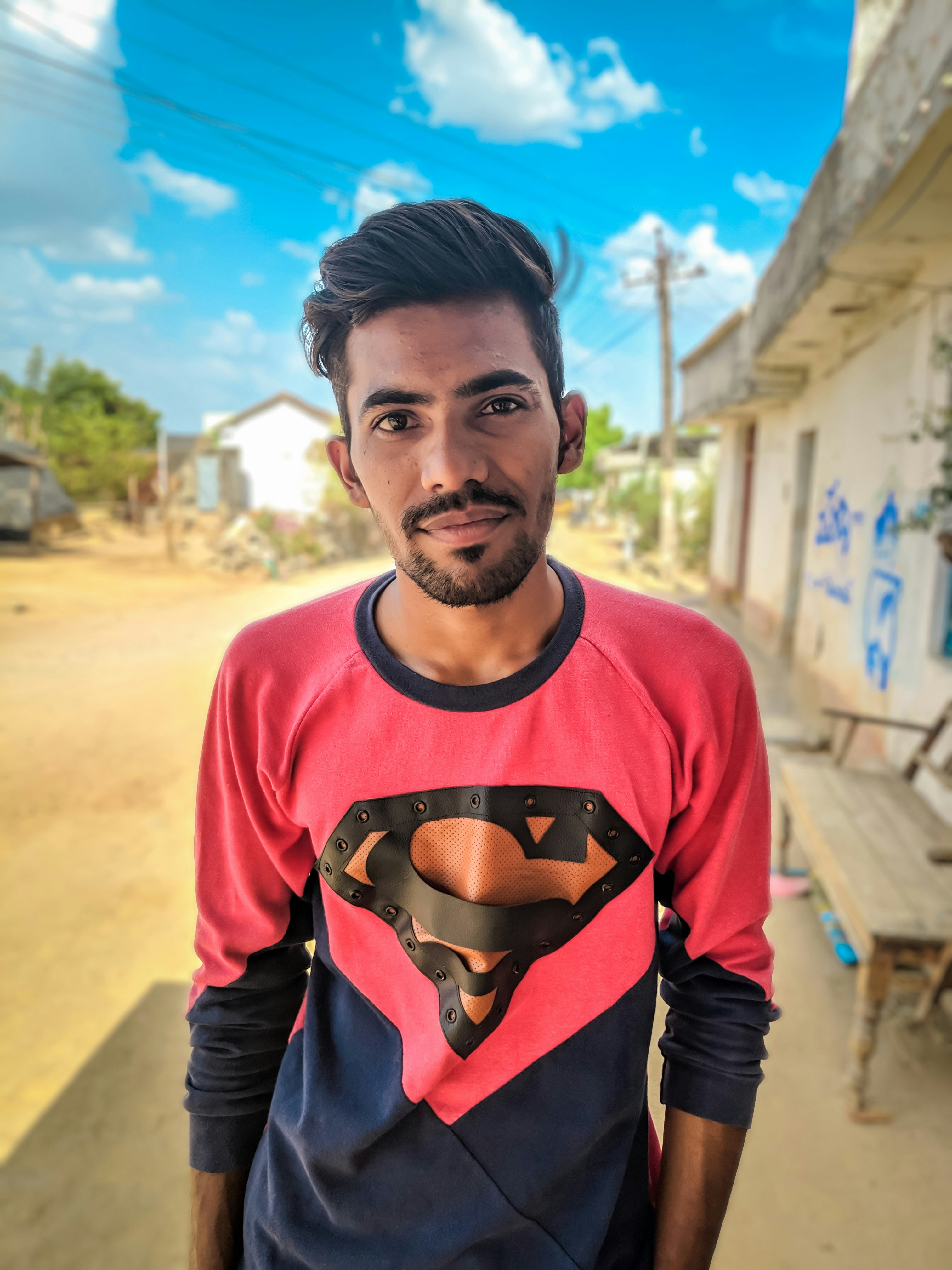 man wearing black and red Superman sweatshirt