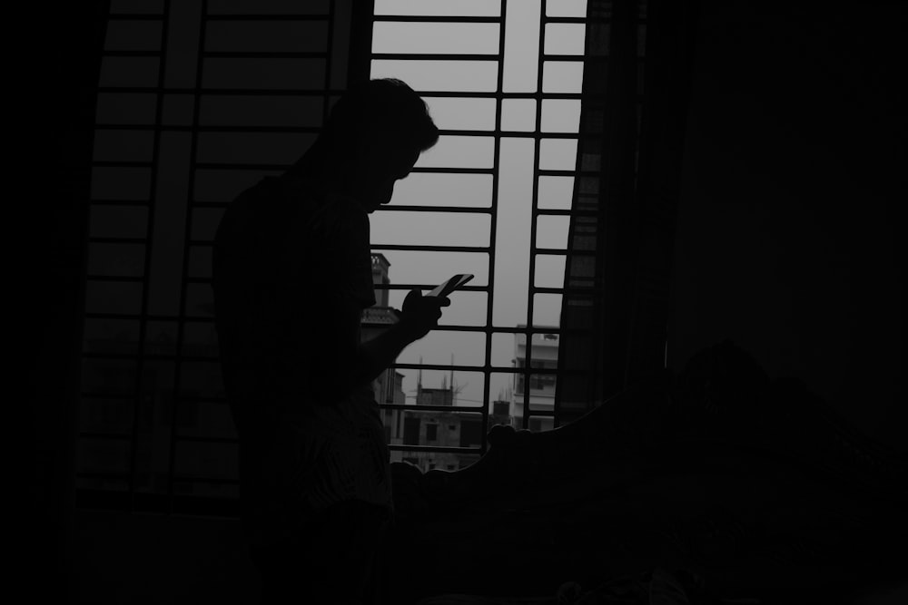 silhouette of man using mobile phone