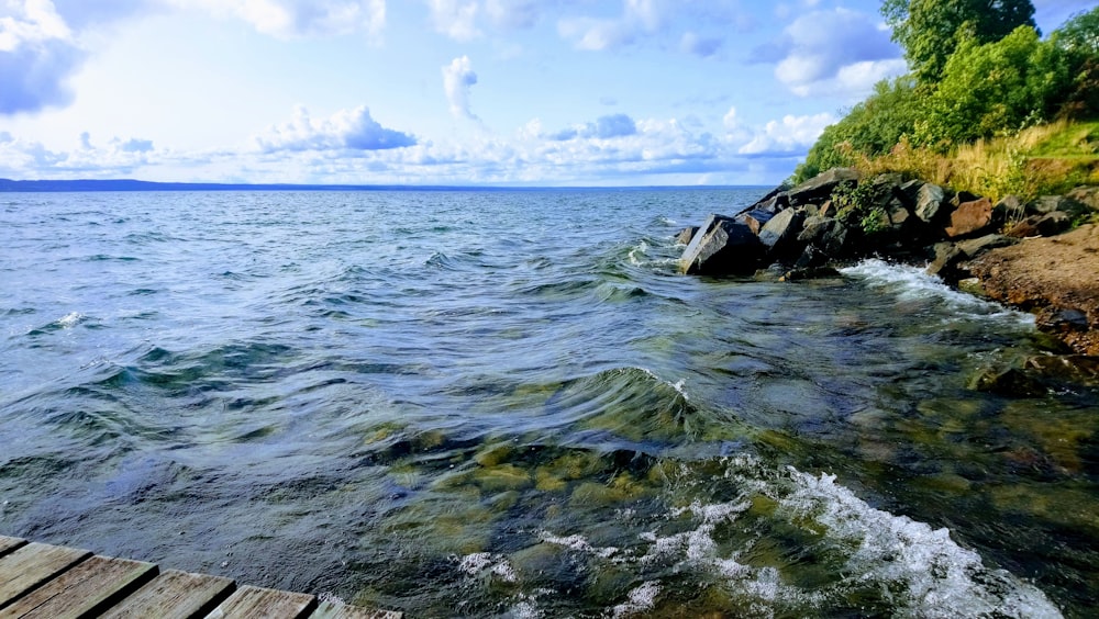 sea waves beside inside under clear blue sky