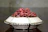 Elegant decorative bowl filled with seasonal ornaments on a centre table.