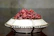 Elegant decorative bowl filled with seasonal ornaments on a centre table.