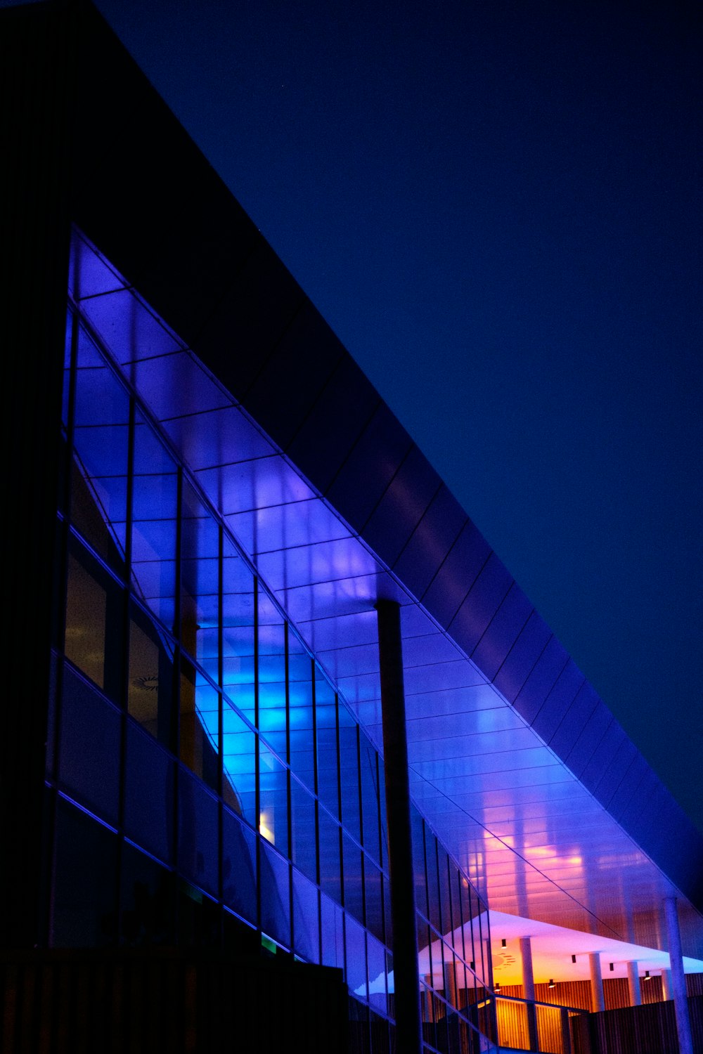 lighted gray building during night