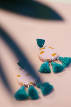 A close-up of handcrafted earrings with natural motifs.