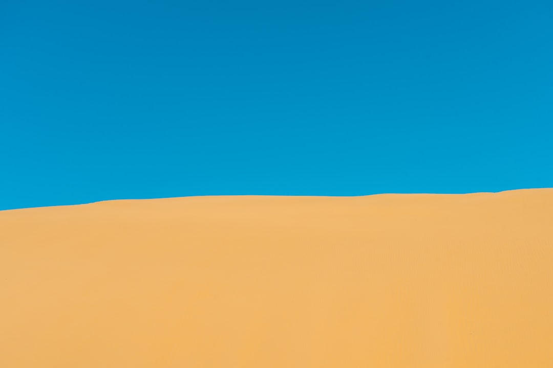 photo of brown sand dunes during daytime