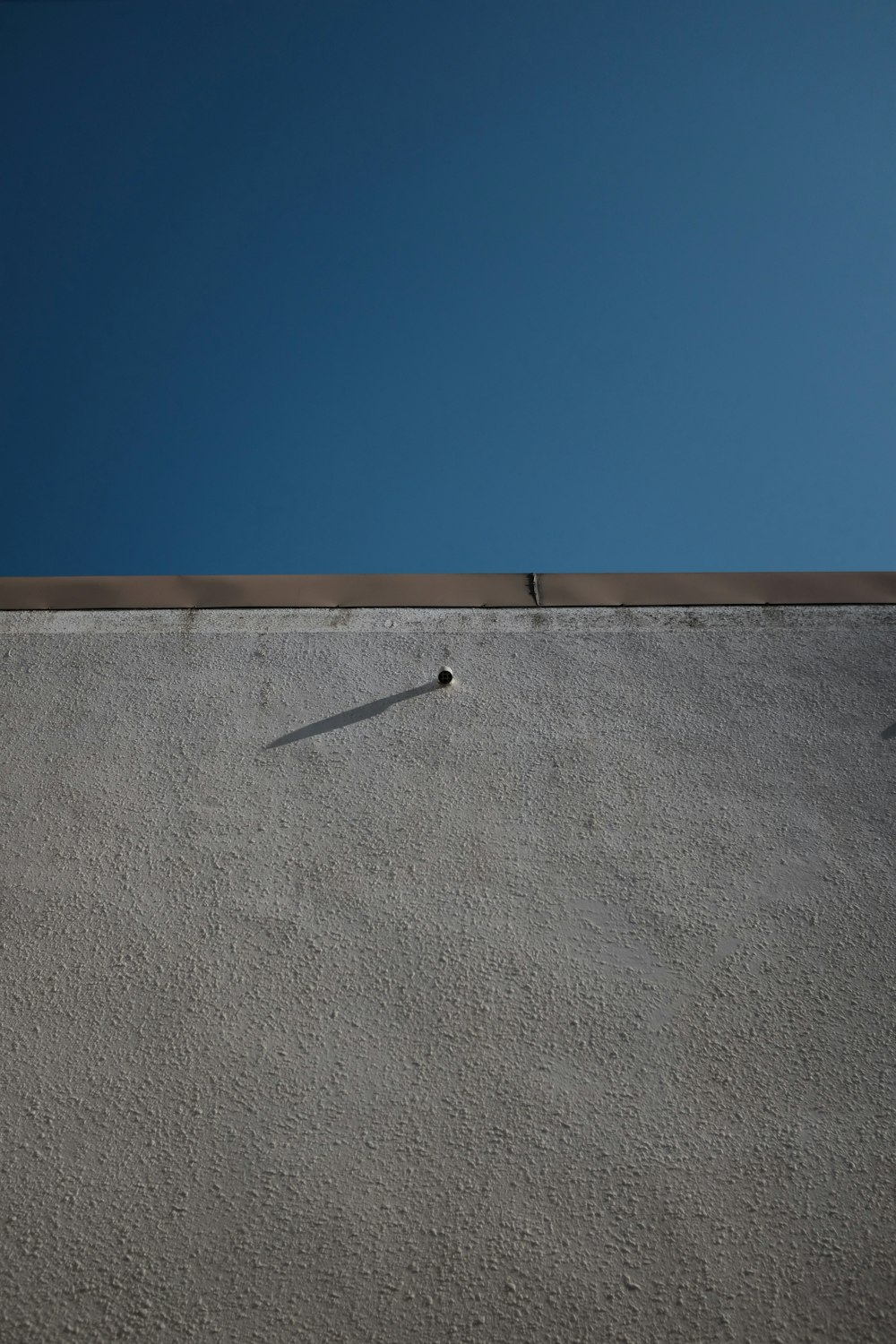 a shadow of a person on the side of a building