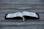An open book displayed on a wooden surface, with visible tabs and a ribbon marker. The pages contain text in a neatly printed format.